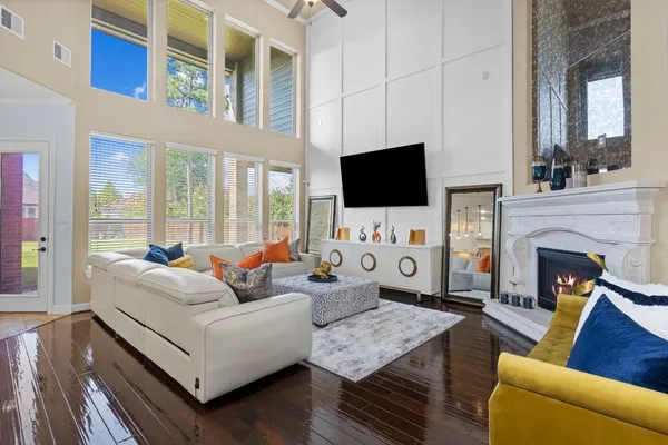 a living room with furniture a flat screen tv and a fireplace