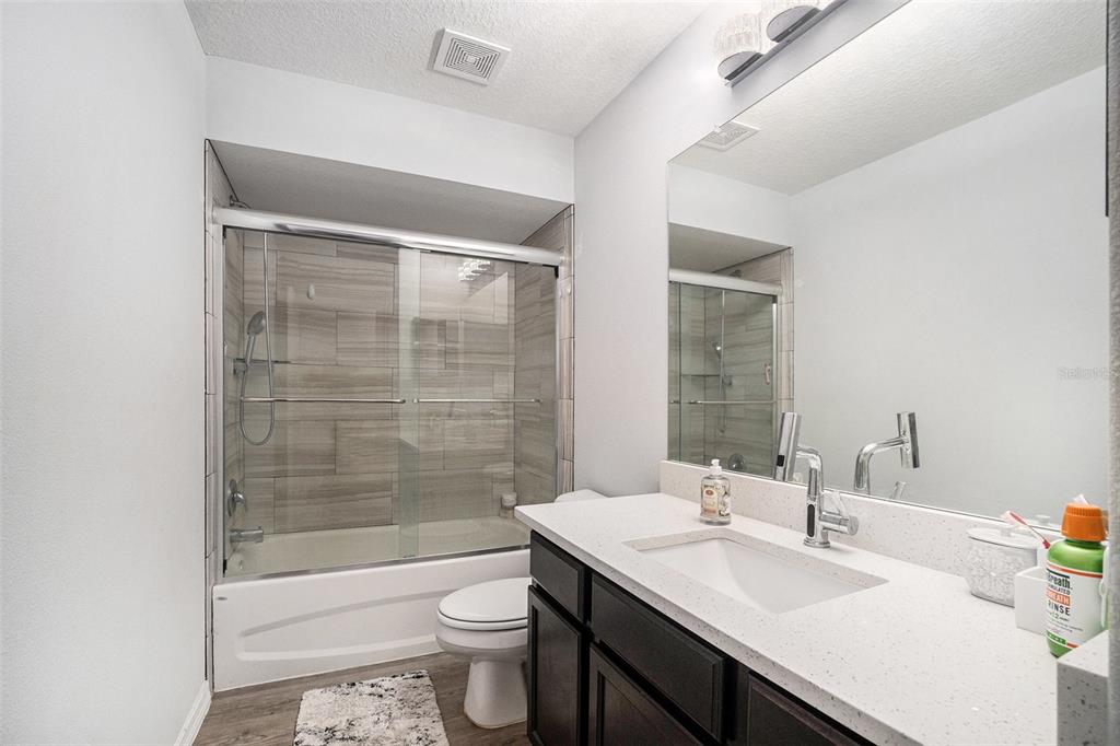7403 Northeast 22nd Ct Road Ocala, FL 34479 - Photo 28 of 37 a bathroom with a sink a toilet and shower