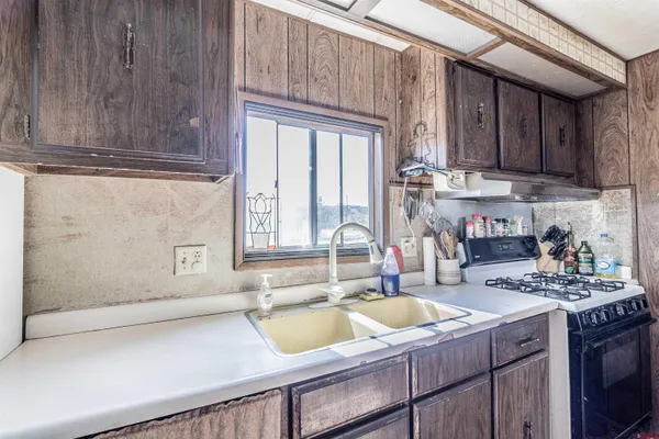 a kitchen with a sink cabinets and a window