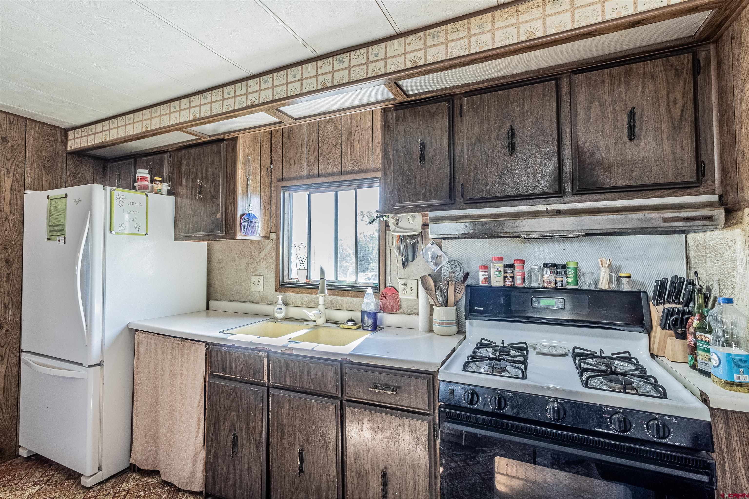 16923 Highway 550 Aztec, NM 87410 - Photo 13 of 45 a kitchen with a stove and a refrigerator