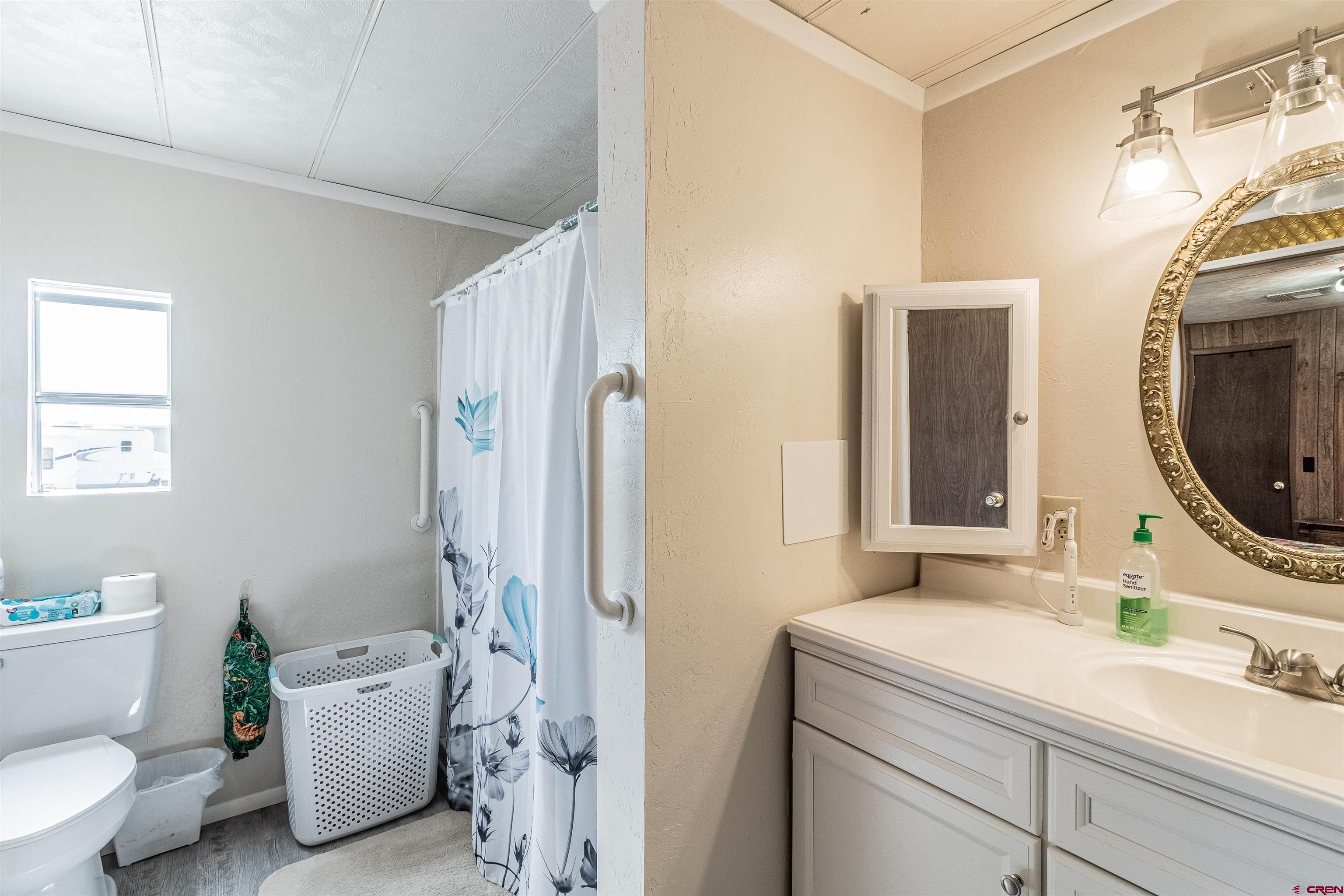16923 Highway 550 Aztec, NM 87410 - Photo 16 of 45 a bathroom with a granite countertop sink toilet and shower