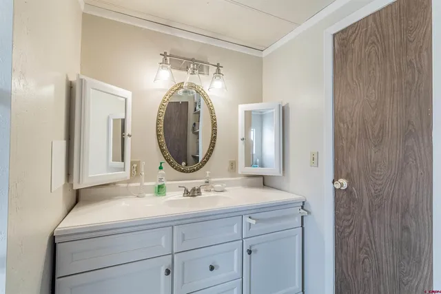 a bathroom with a double vanity sink and a mirror
