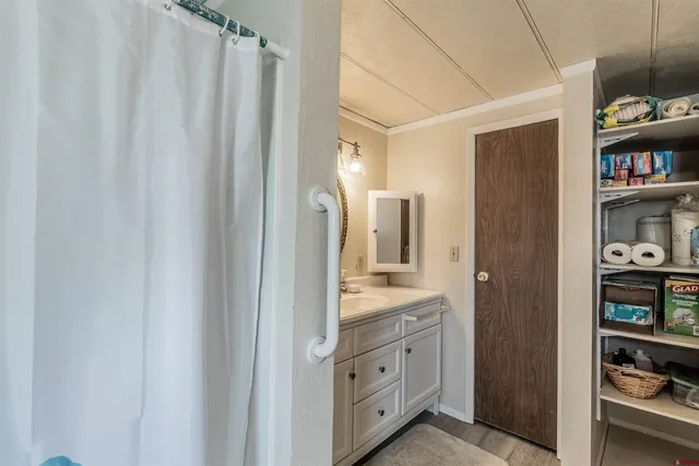 a spacious bathroom with a double vanity sink and a mirror