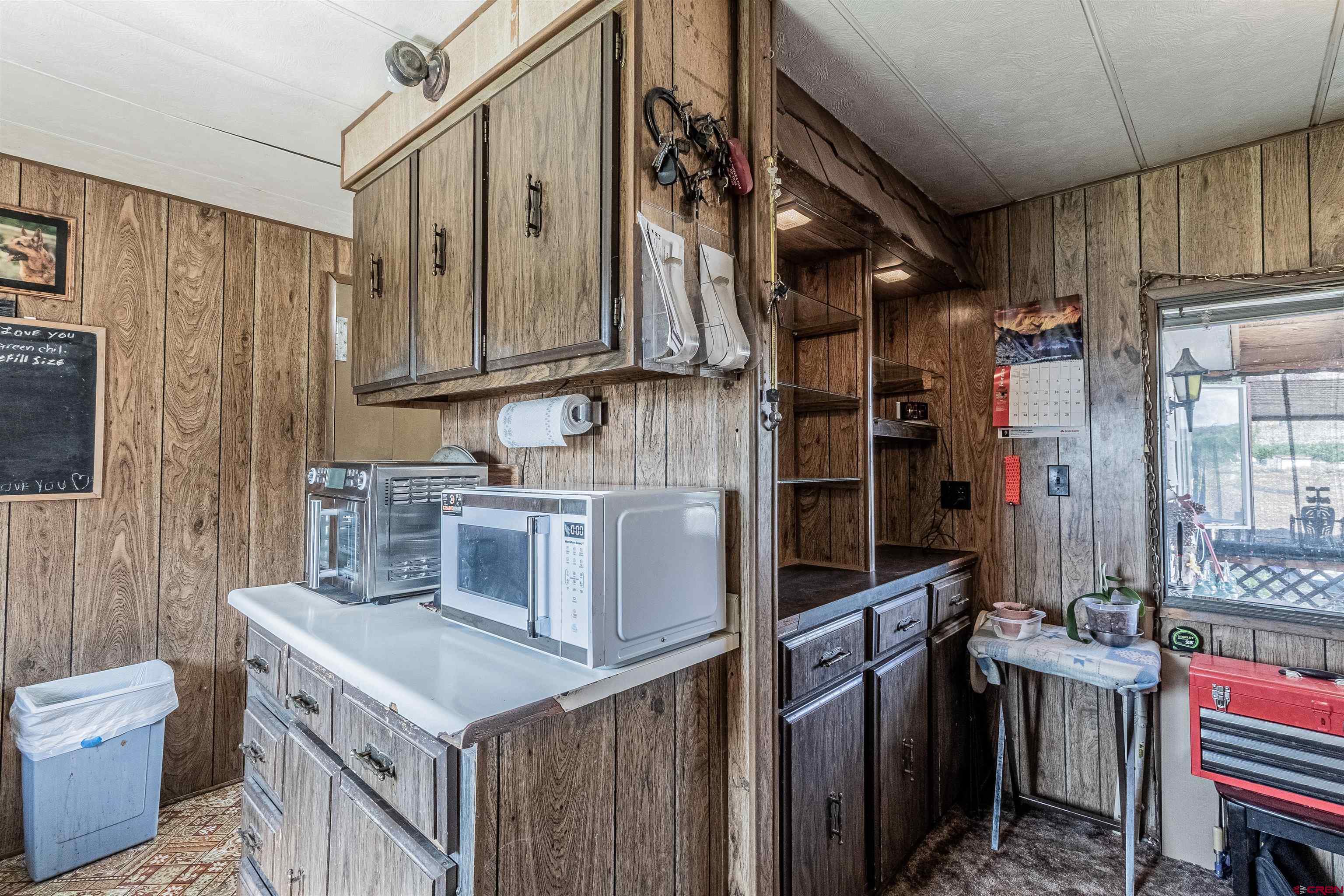 16923 Highway 550 Aztec, NM 87410 - Photo 20 of 45 a kitchen with a stove and a refrigerator