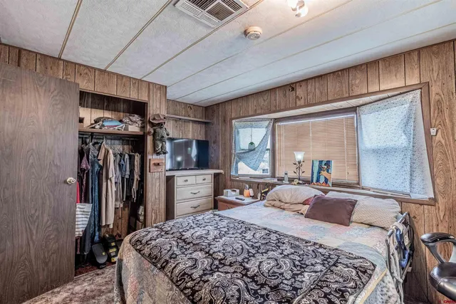 a bedroom with a large bed and a dresser