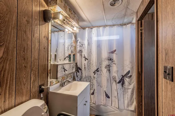 a bathroom with a sink toilet and shower