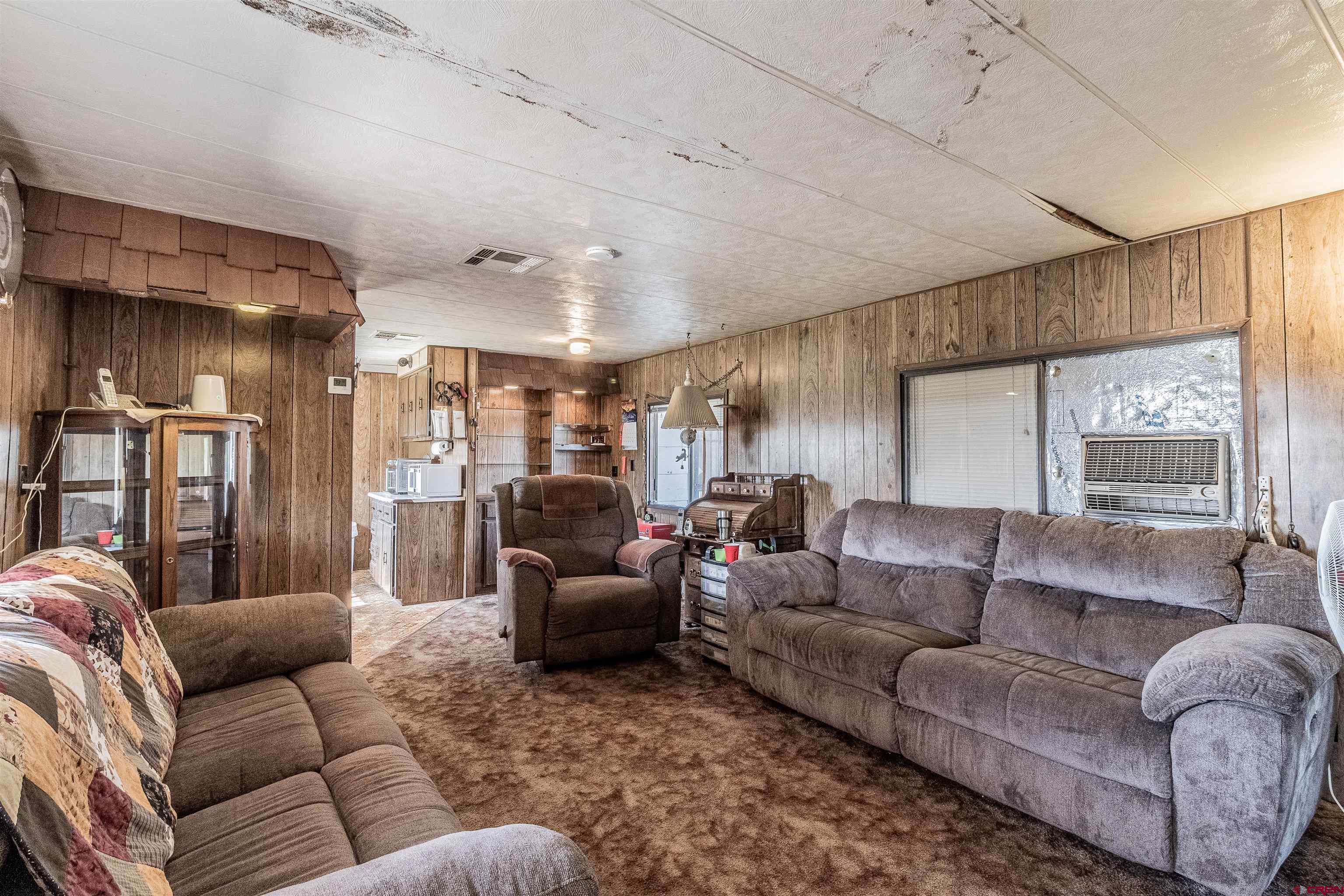 16923 Highway 550 Aztec, NM 87410 - Photo 24 of 45 a living room with furniture and a large window