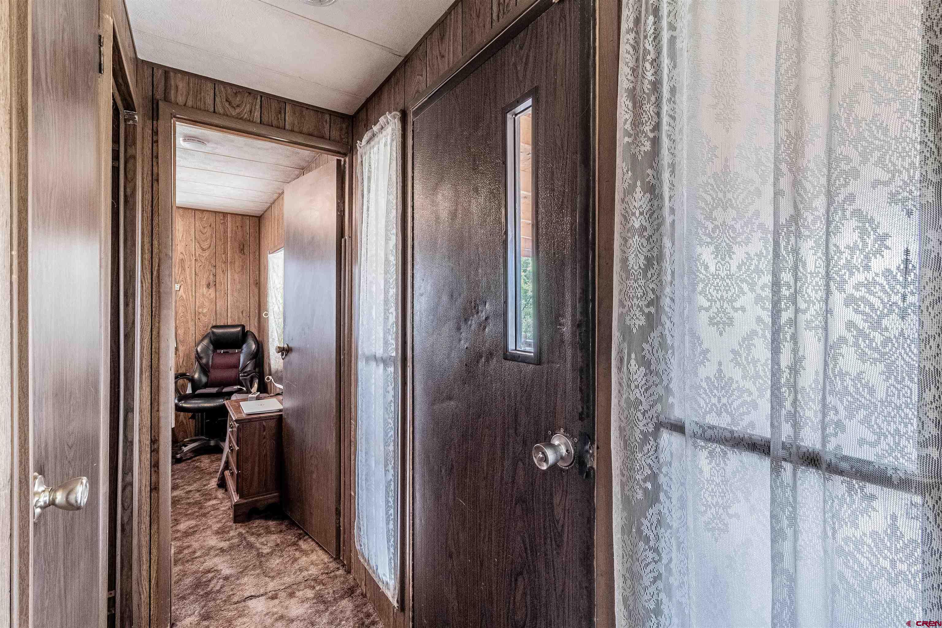 16923 Highway 550 Aztec, NM 87410 - Photo 25 of 45 a view of a hallway with a livingroom and a bathroom