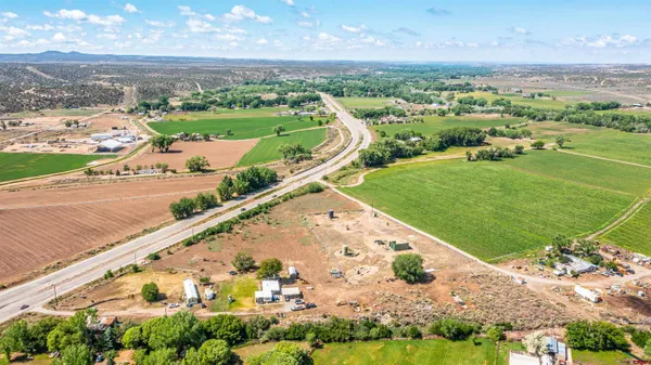a living room with furniture and a ceiling fan