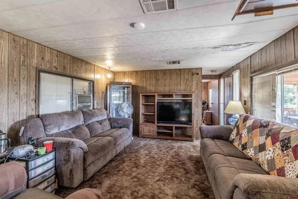 a kitchen with stainless steel appliances granite countertop a refrigerator a stove and a sink with wooden cabinets