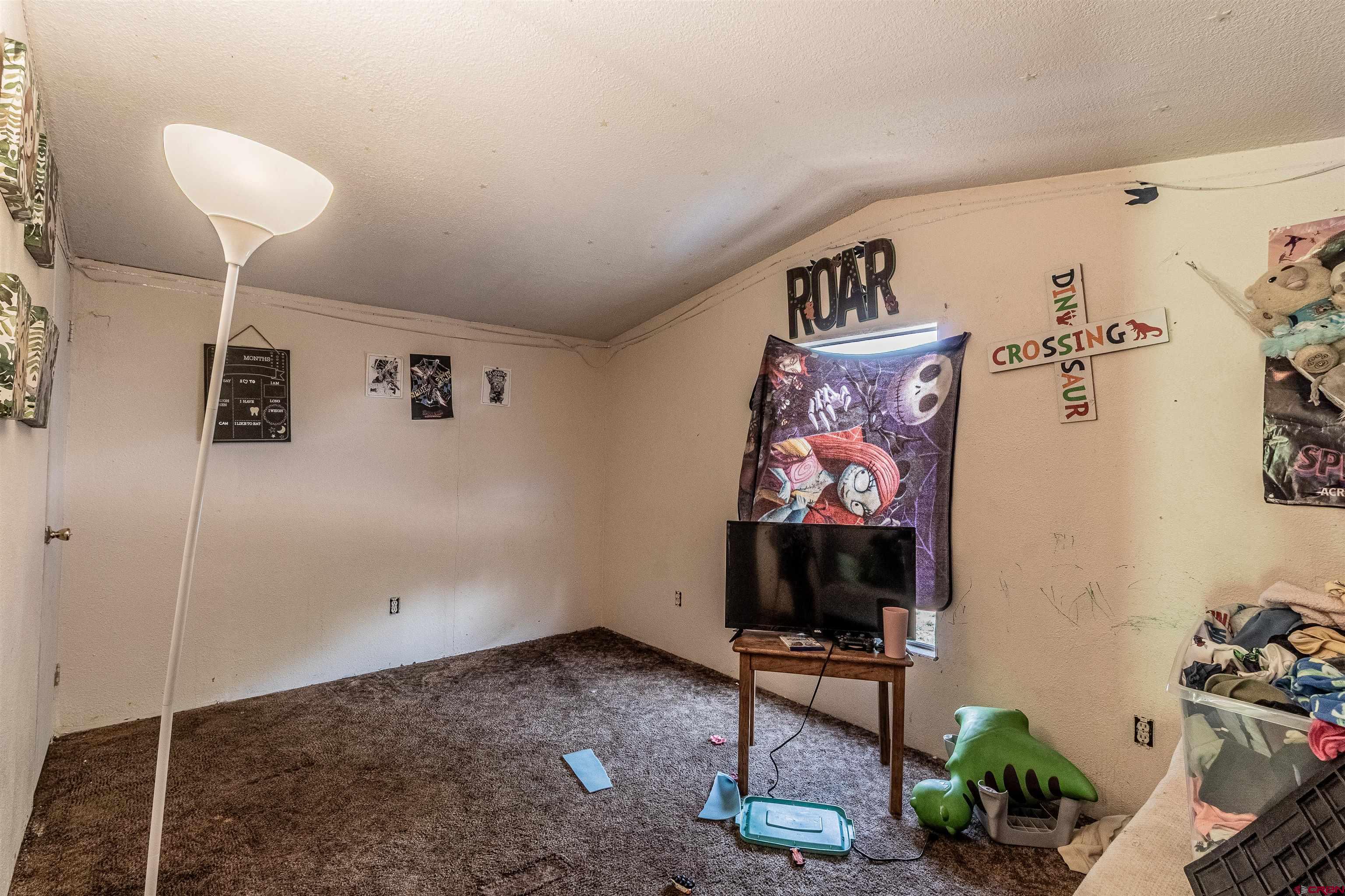 16923 Highway 550 Aztec, NM 87410 - Photo 34 of 45 a living room with furniture and a flat screen tv