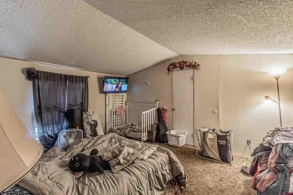 a living room with lots of furniture and gym equipment