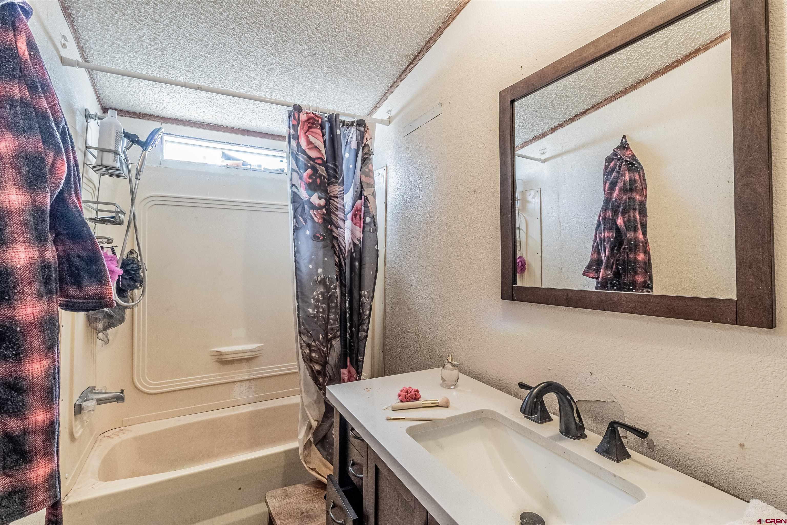 16923 Highway 550 Aztec, NM 87410 - Photo 38 of 45 a bathroom with a sink and a bathtub