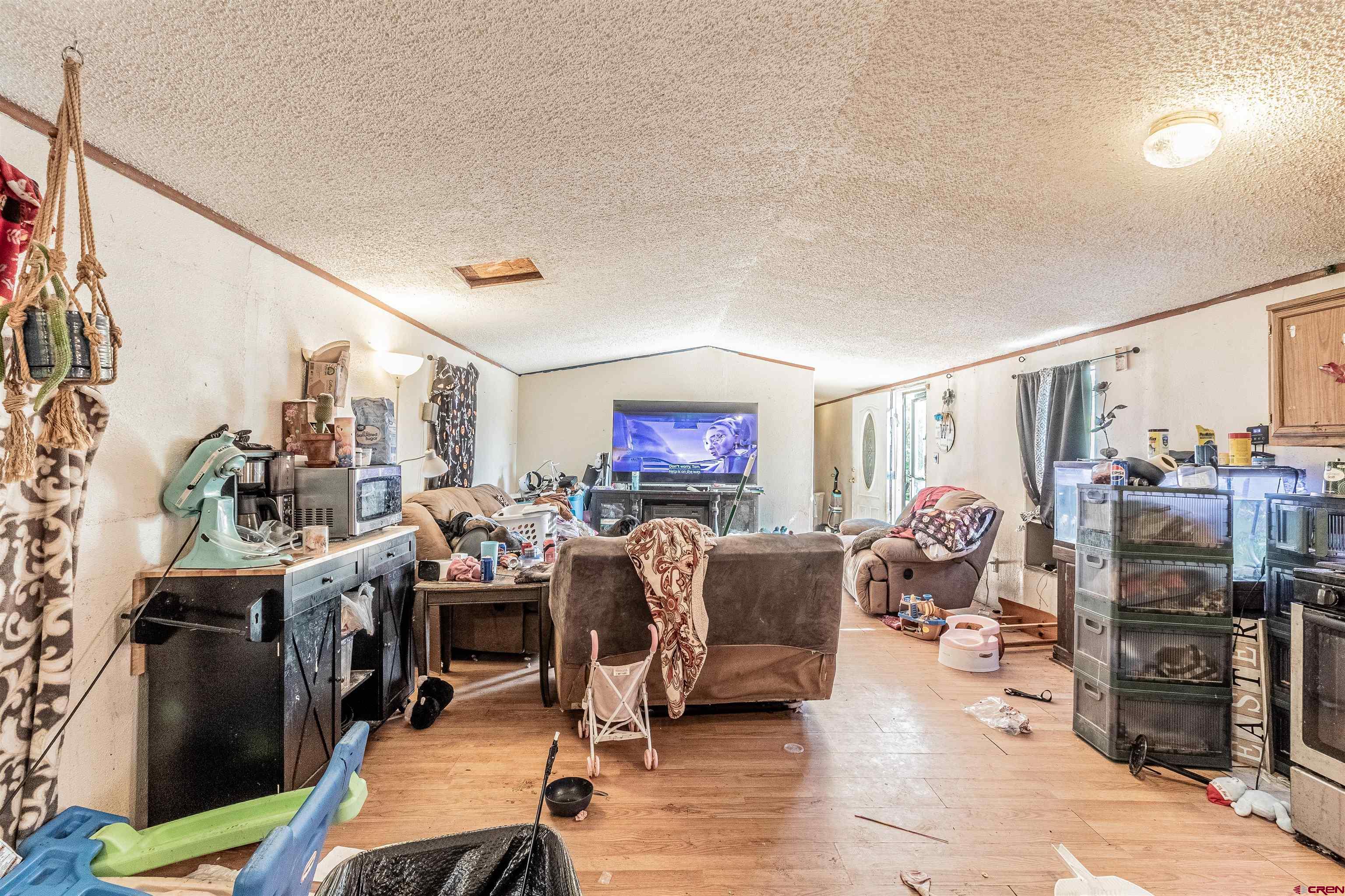 16923 Highway 550 Aztec, NM 87410 - Photo 39 of 45 a living room with lots of furniture and gym equipment