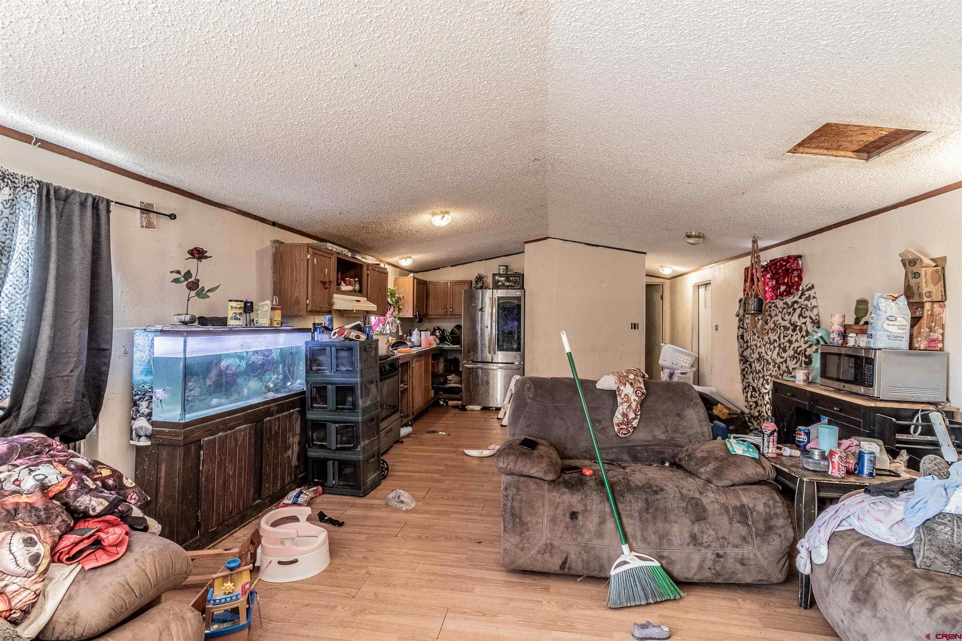 16923 Highway 550 Aztec, NM 87410 - Photo 40 of 45 a living room with lots of furniture and a flat screen tv