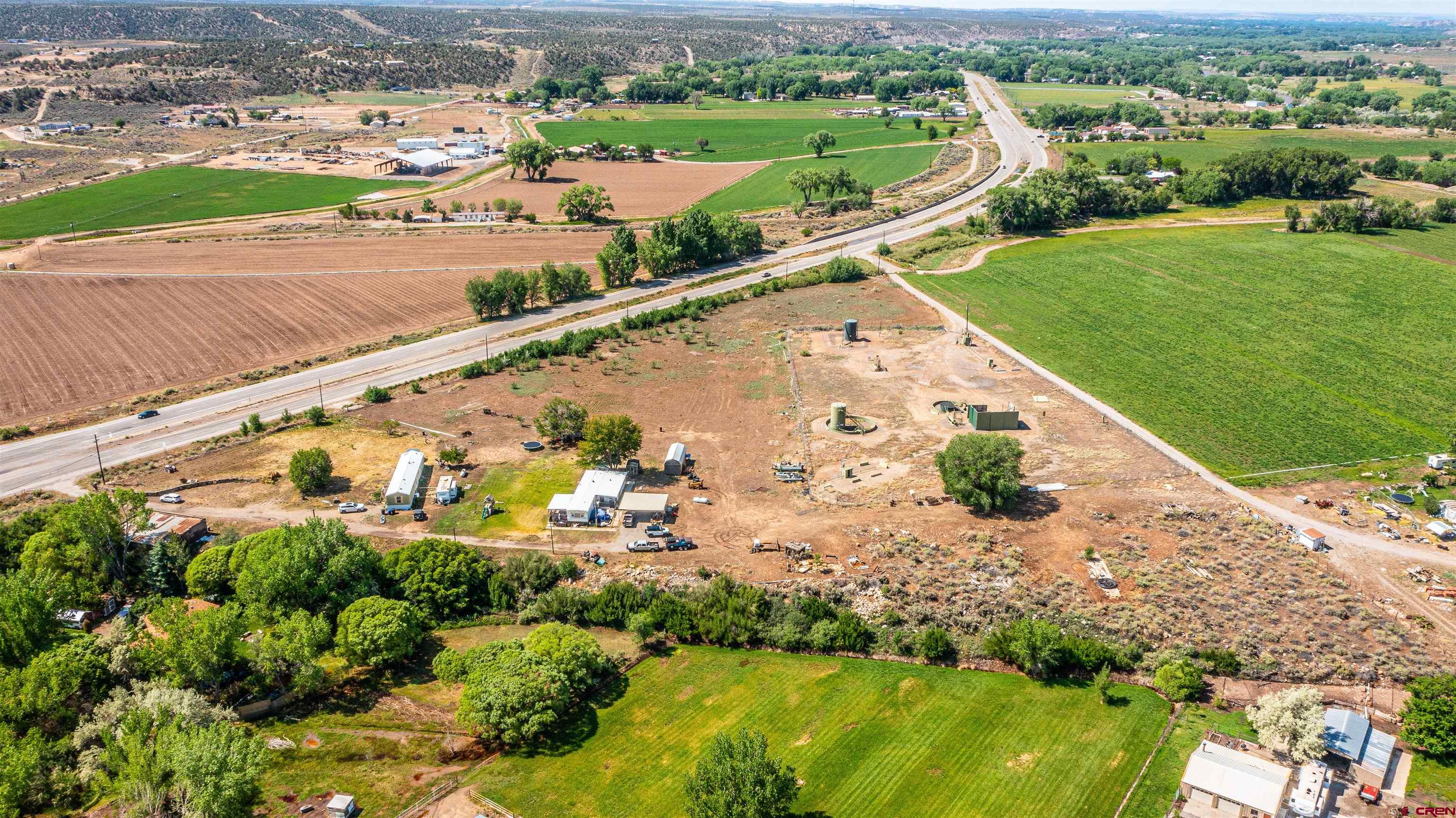 16923 Highway 550 Aztec, NM 87410 - Photo 4 of 45 an aerial view of a house with a yard and lake view