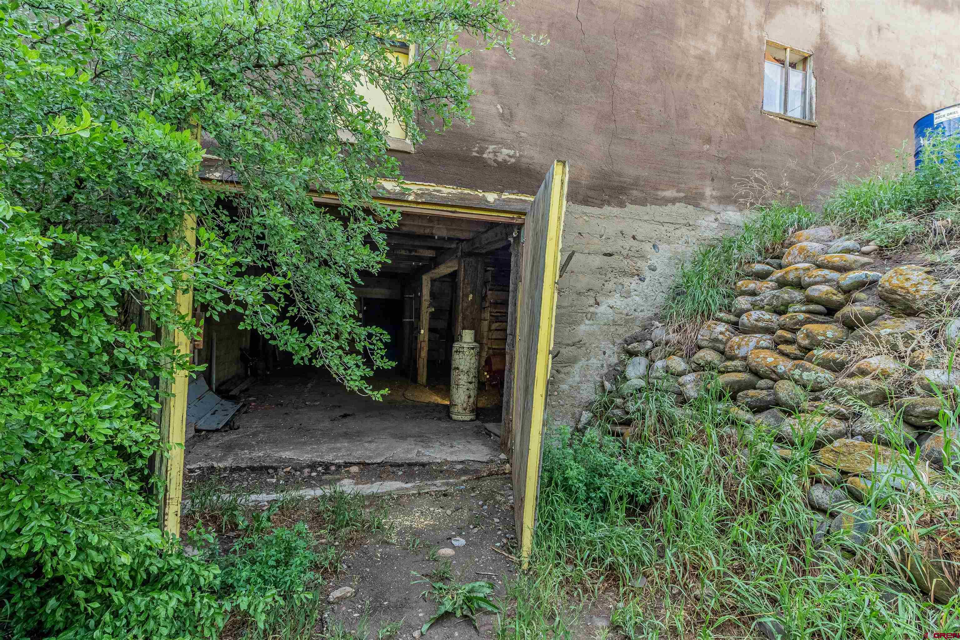 16923 Highway 550 Aztec, NM 87410 - Photo 45 of 45 a view of a pathway of a house with plants and garden