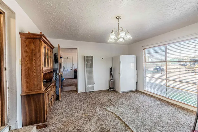 a view of a livingroom with a ceiling fan and window