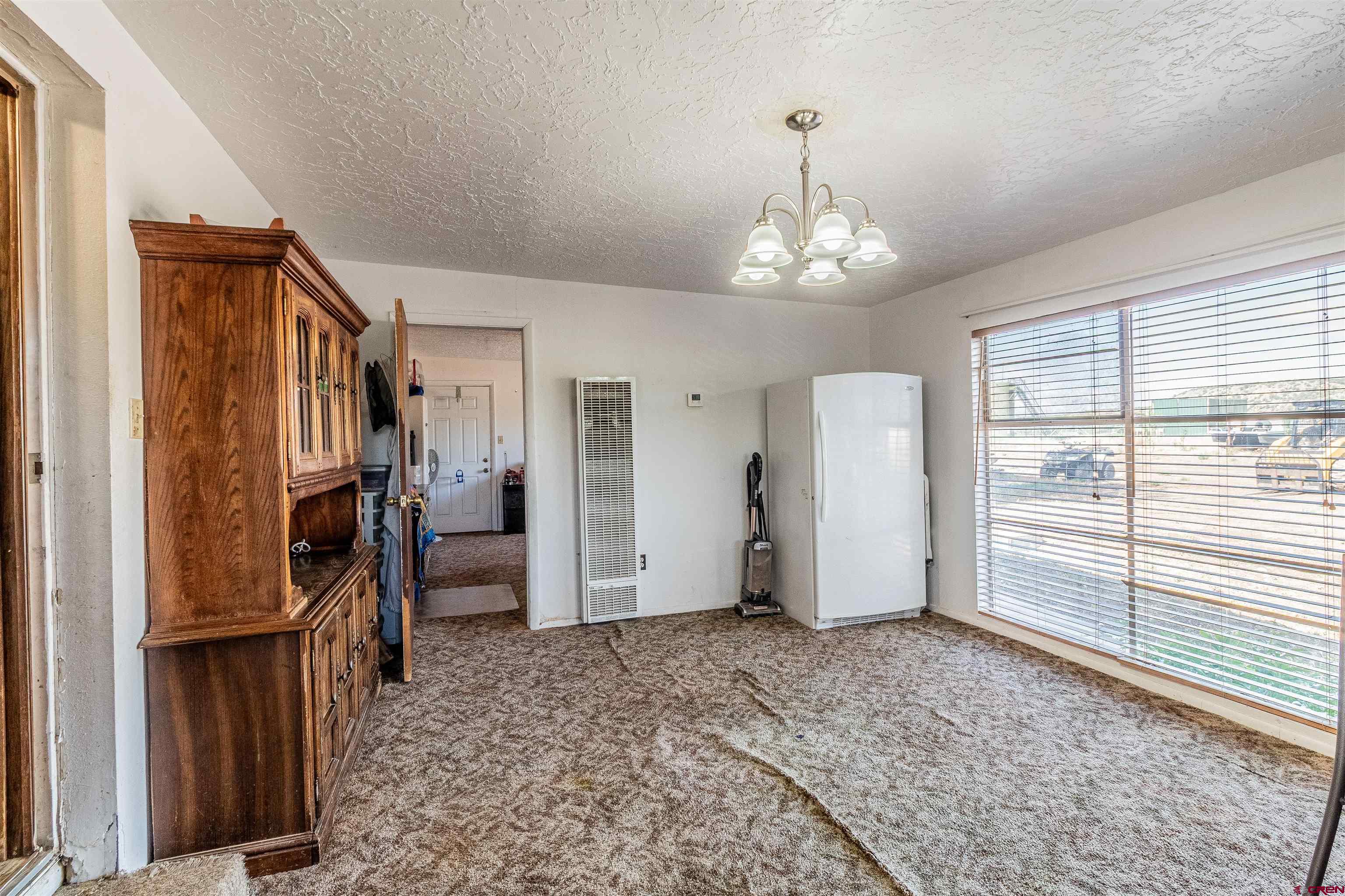 16923 Highway 550 Aztec, NM 87410 - Photo 6 of 45 a view of a livingroom with a ceiling fan and window