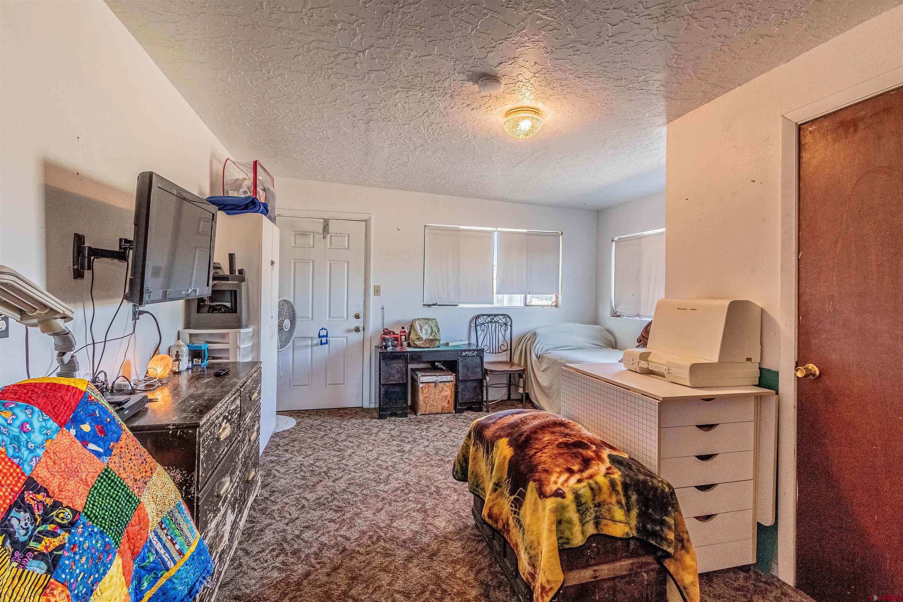 16923 Highway 550 Aztec, NM 87410 - Photo 8 of 45 a workspace with furniture and bedroom