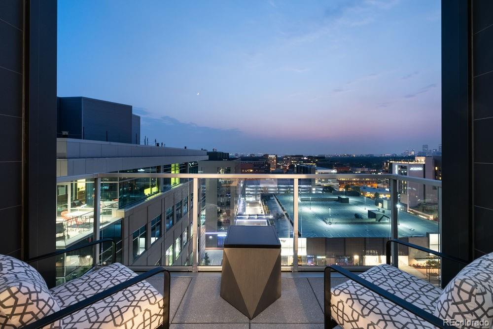 a view of a balcony with two chairs and a potted plant