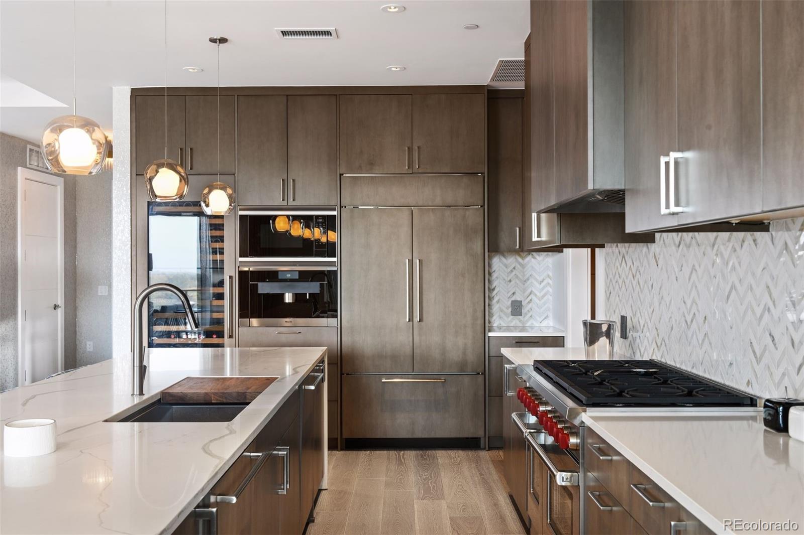 155 Steele Street, Unit 1117 Denver, CO 80206 - Photo 12 of 40 a kitchen with granite countertop a sink and stainless steel appliances