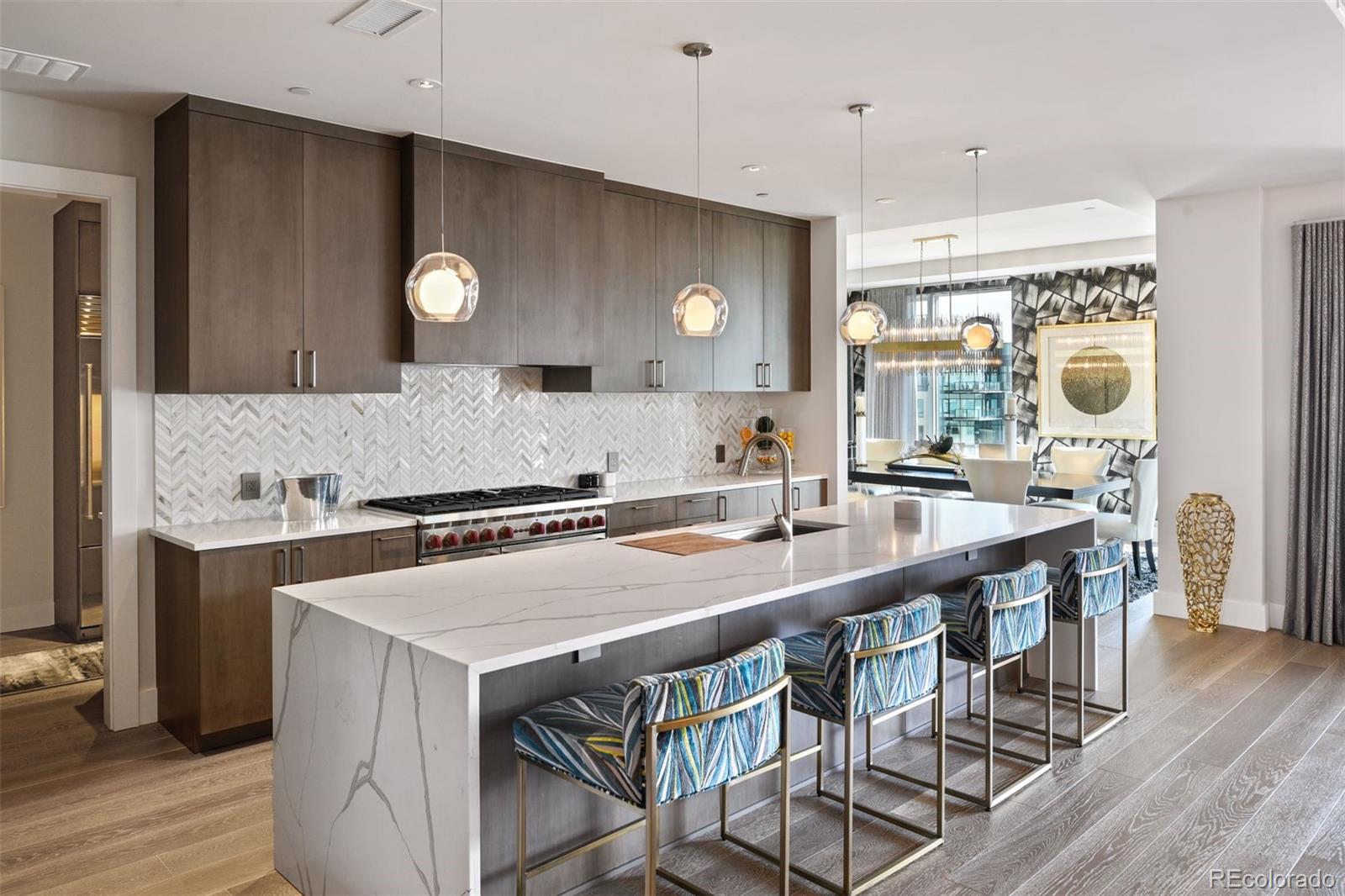 155 Steele Street, Unit 1117 Denver, CO 80206 - Photo 13 of 40 a kitchen with a table and chairs