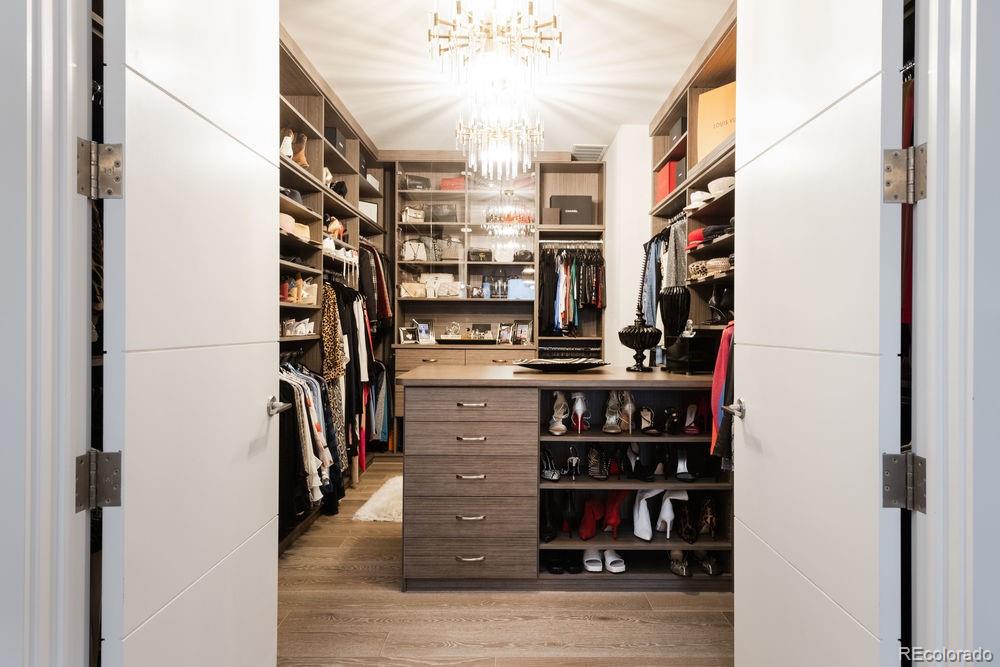 155 Steele Street, Unit 1117 Denver, CO 80206 - Photo 17 of 40 a view of walk in closet with clothes and shoes