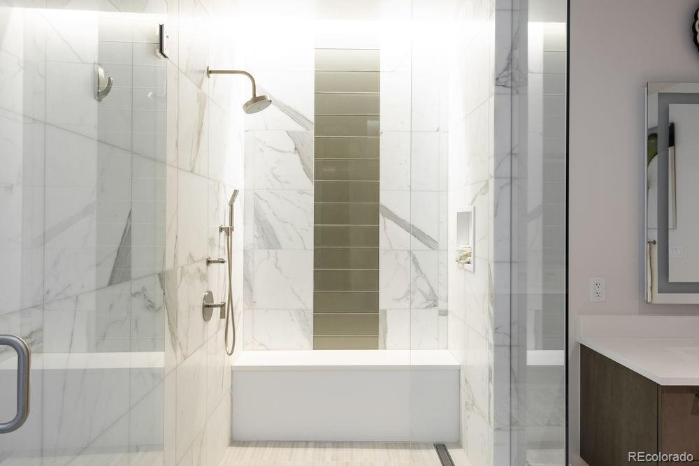 155 Steele Street, Unit 1117 Denver, CO 80206 - Photo 20 of 40 a bathroom with a bathtub and a shower