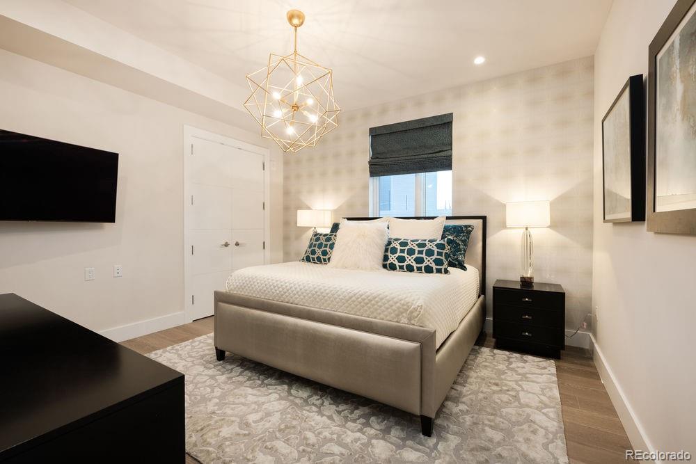 155 Steele Street, Unit 1117 Denver, CO 80206 - Photo 22 of 40 a bedroom with a bed window and a flat screen tv