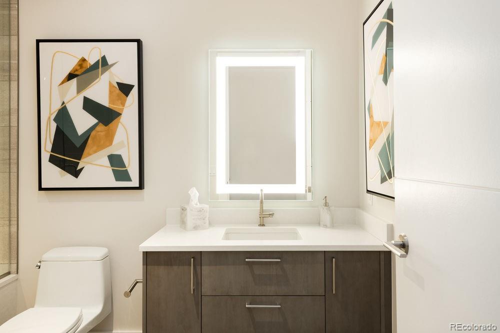 155 Steele Street, Unit 1117 Denver, CO 80206 - Photo 23 of 40 a bathroom with a toilet a sink and mirror