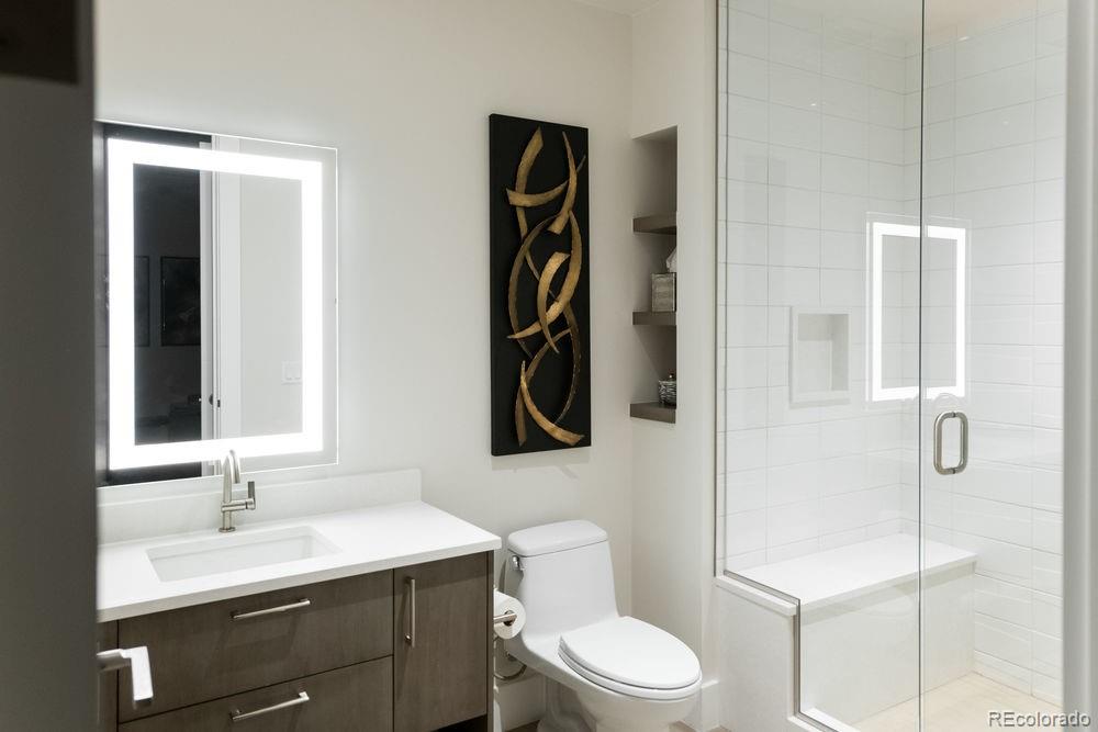 155 Steele Street, Unit 1117 Denver, CO 80206 - Photo 27 of 40 a bathroom with a toilet sink a shower and