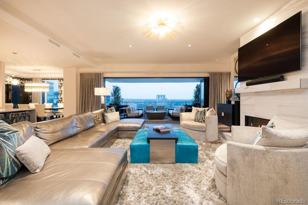 155 Steele Street, Unit 1117 Denver, CO 80206 - Photo 5 of 40 a living room with fireplace furniture and a flat screen tv