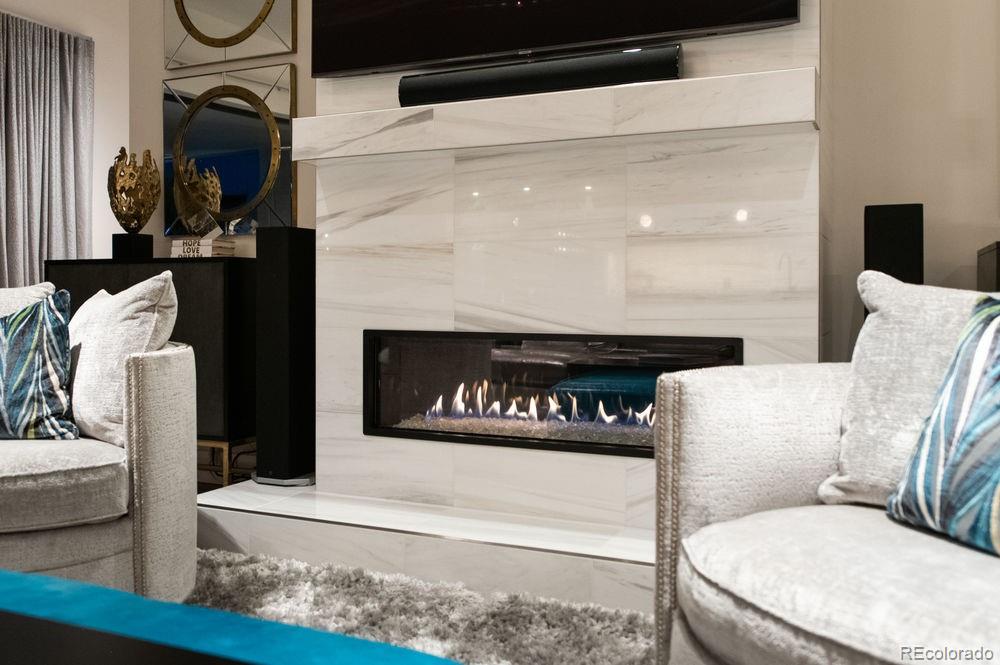 155 Steele Street, Unit 1117 Denver, CO 80206 - Photo 7 of 40 a living room with furniture and a fireplace