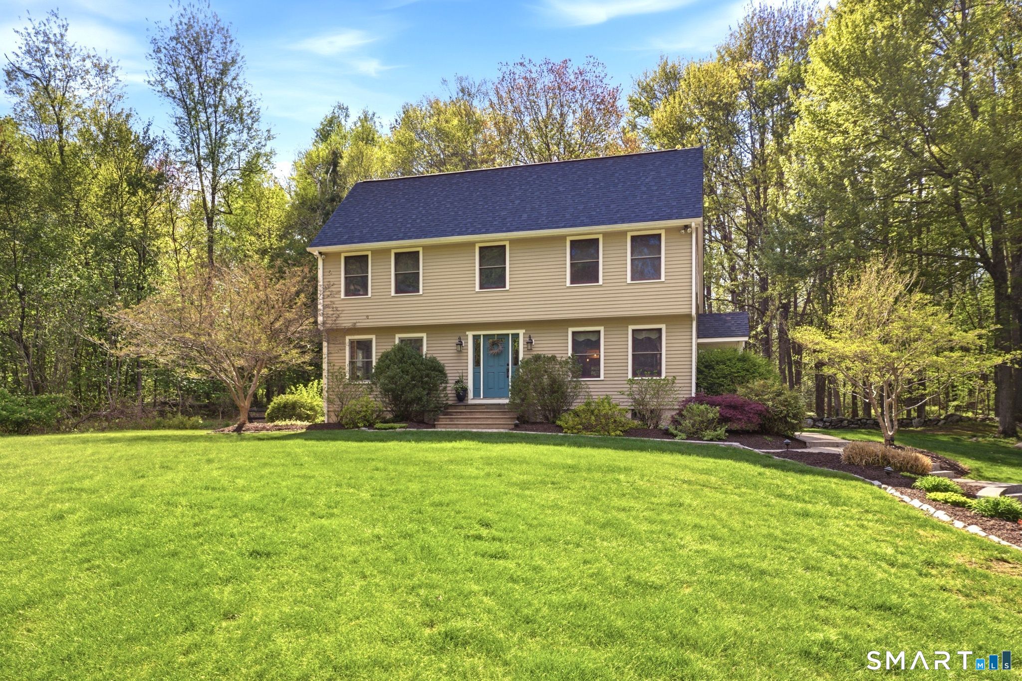 174 Walnut Hill Road Hartland, CT 06027 - Photo 2 of 36 a front view of a house with a yard