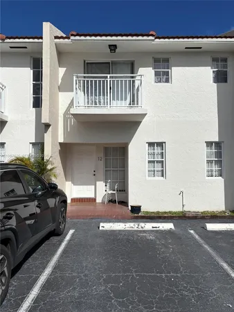 a view of a car park in front of house