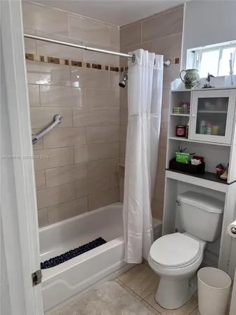 a bathroom with a shower a toilet and a sink