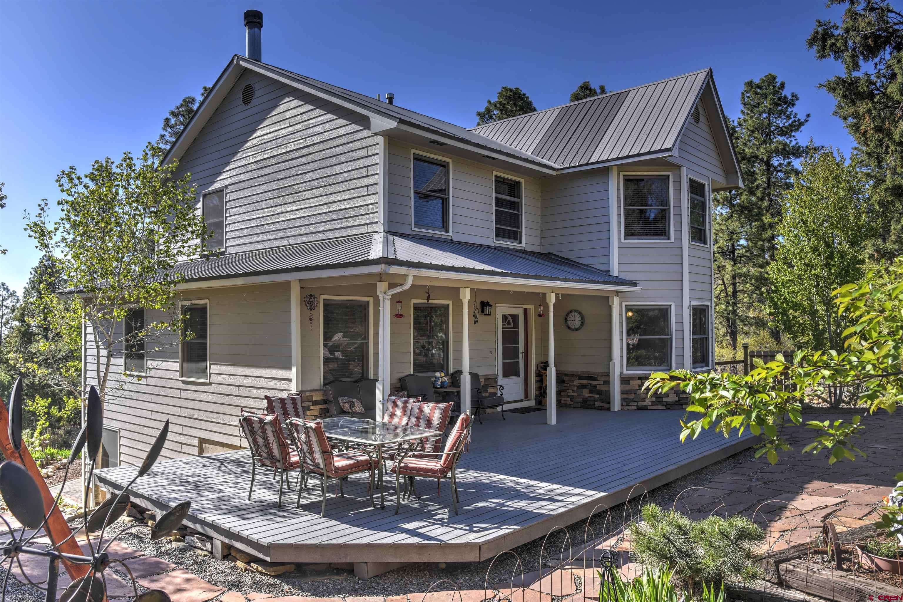 a front view of house with yard outdoor seating and green space