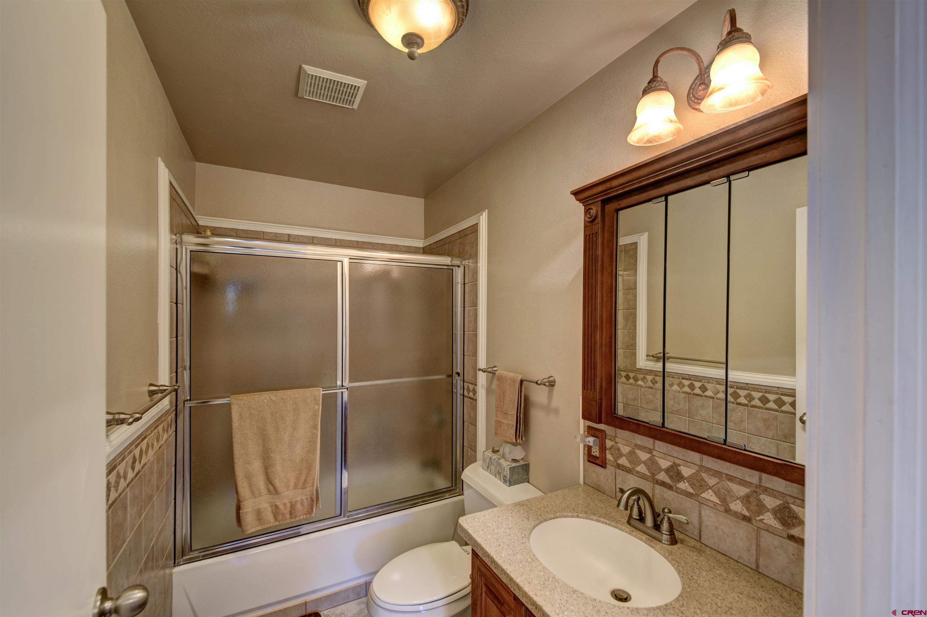 1172 Ridge Road Durango, CO 81303 - Photo 12 of 28 a bathroom with a toilet sink vanity and mirror