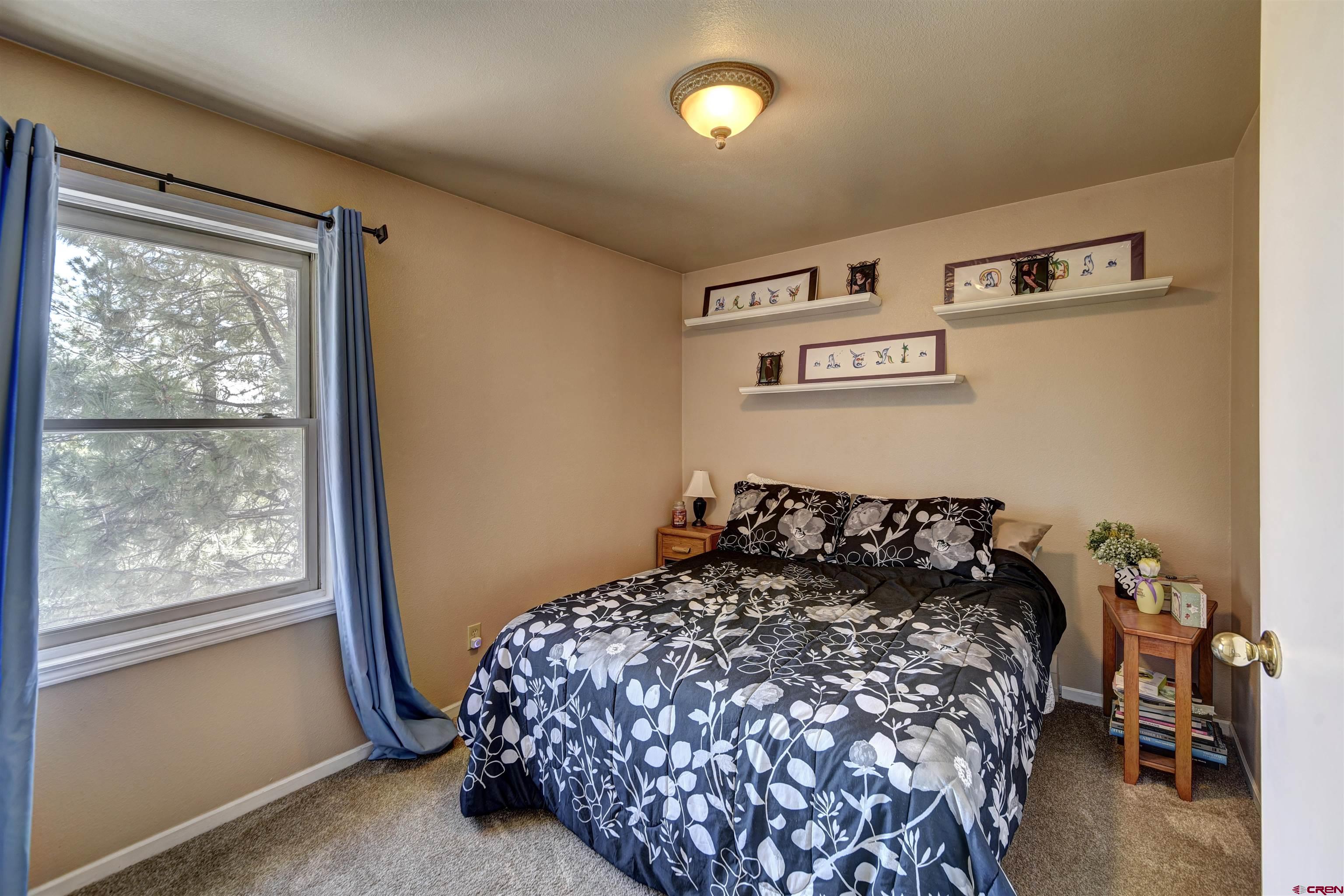 1172 Ridge Road Durango, CO 81303 - Photo 13 of 28 a bedroom with a bed and a window