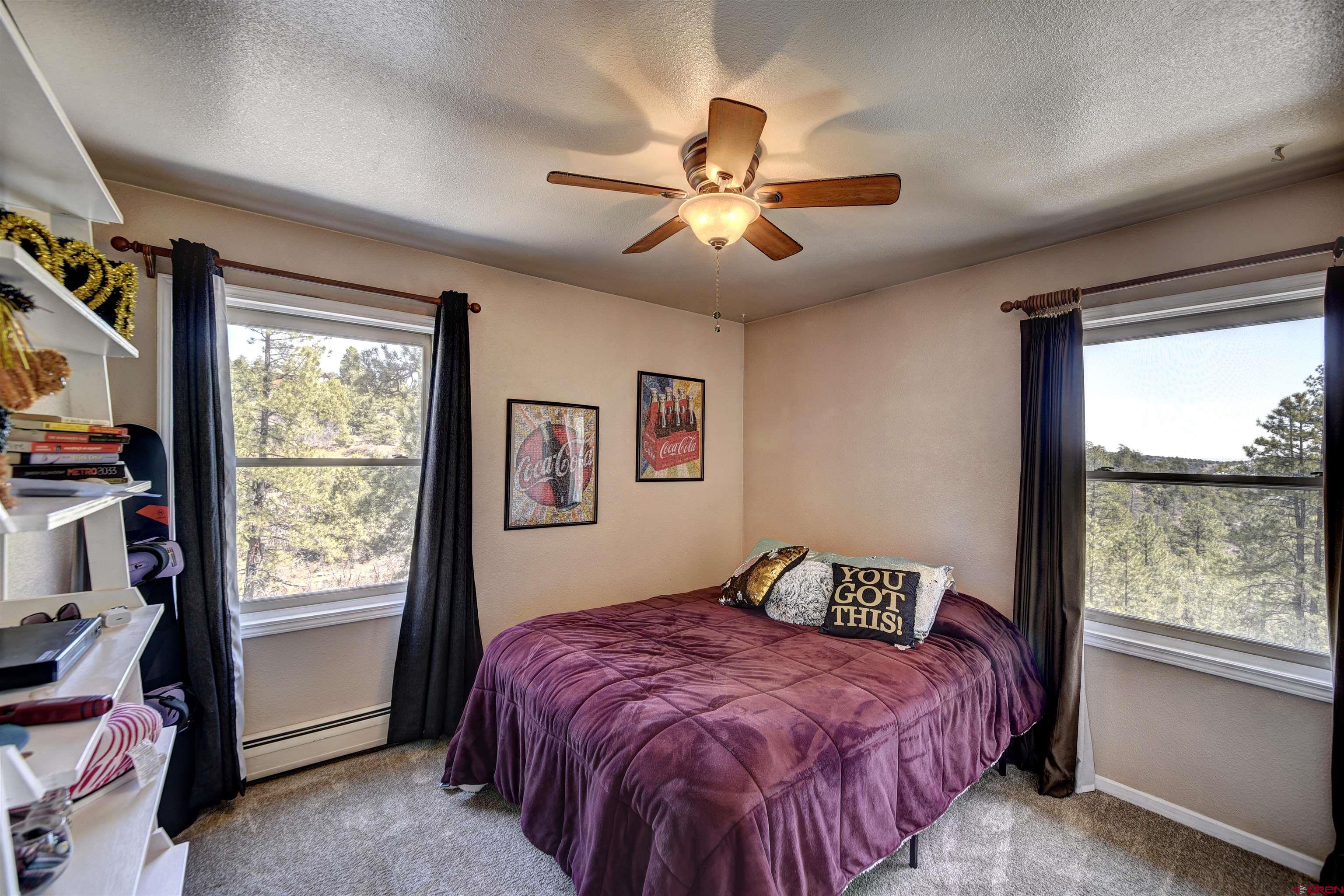 1172 Ridge Road Durango, CO 81303 - Photo 14 of 28 a bedroom with a large bed and a window