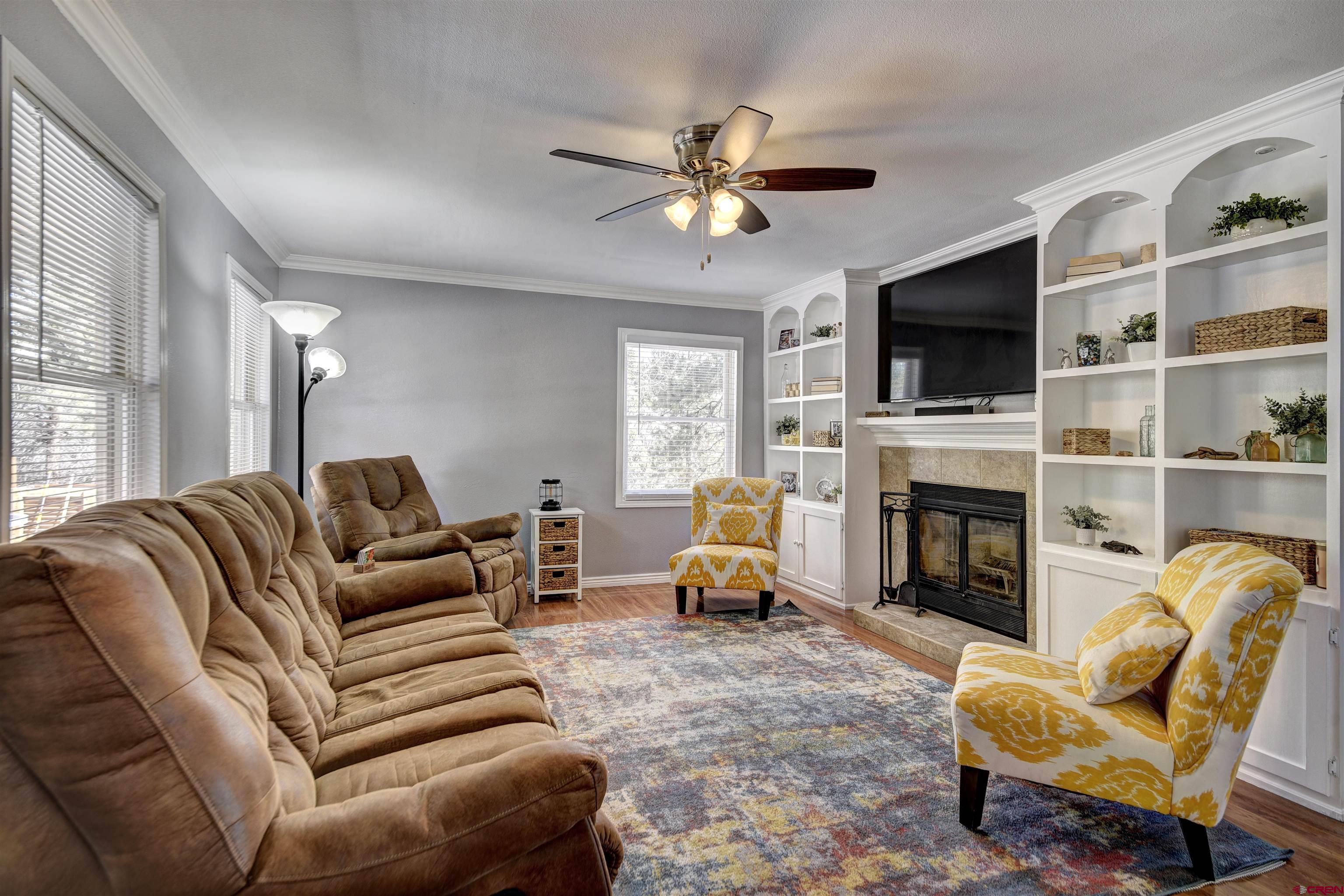 1172 Ridge Road Durango, CO 81303 - Photo 22 of 28 a living room with furniture a fireplace and a flat screen tv