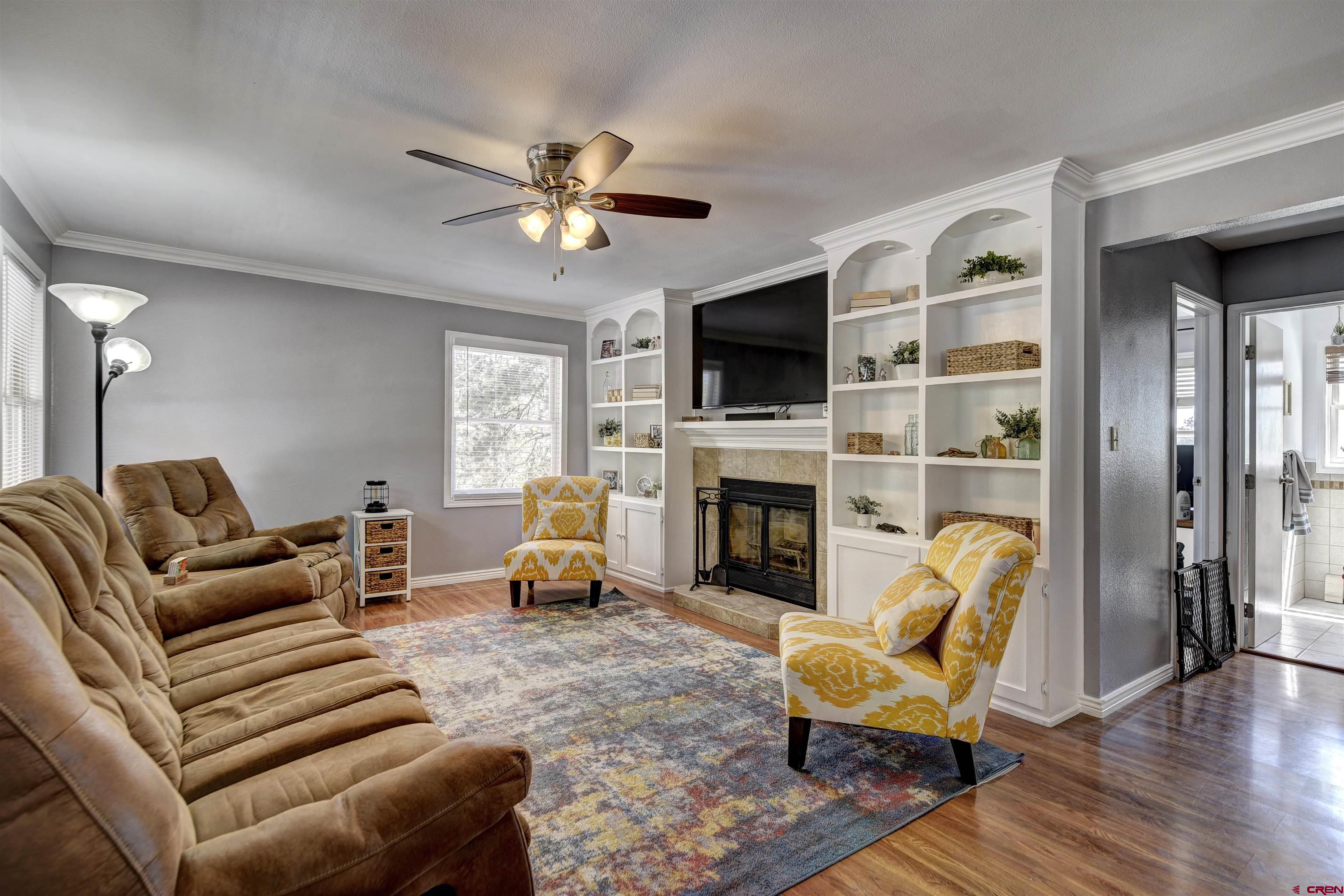 1172 Ridge Road Durango, CO 81303 - Photo 23 of 28 a living room with furniture a fireplace and a flat screen tv