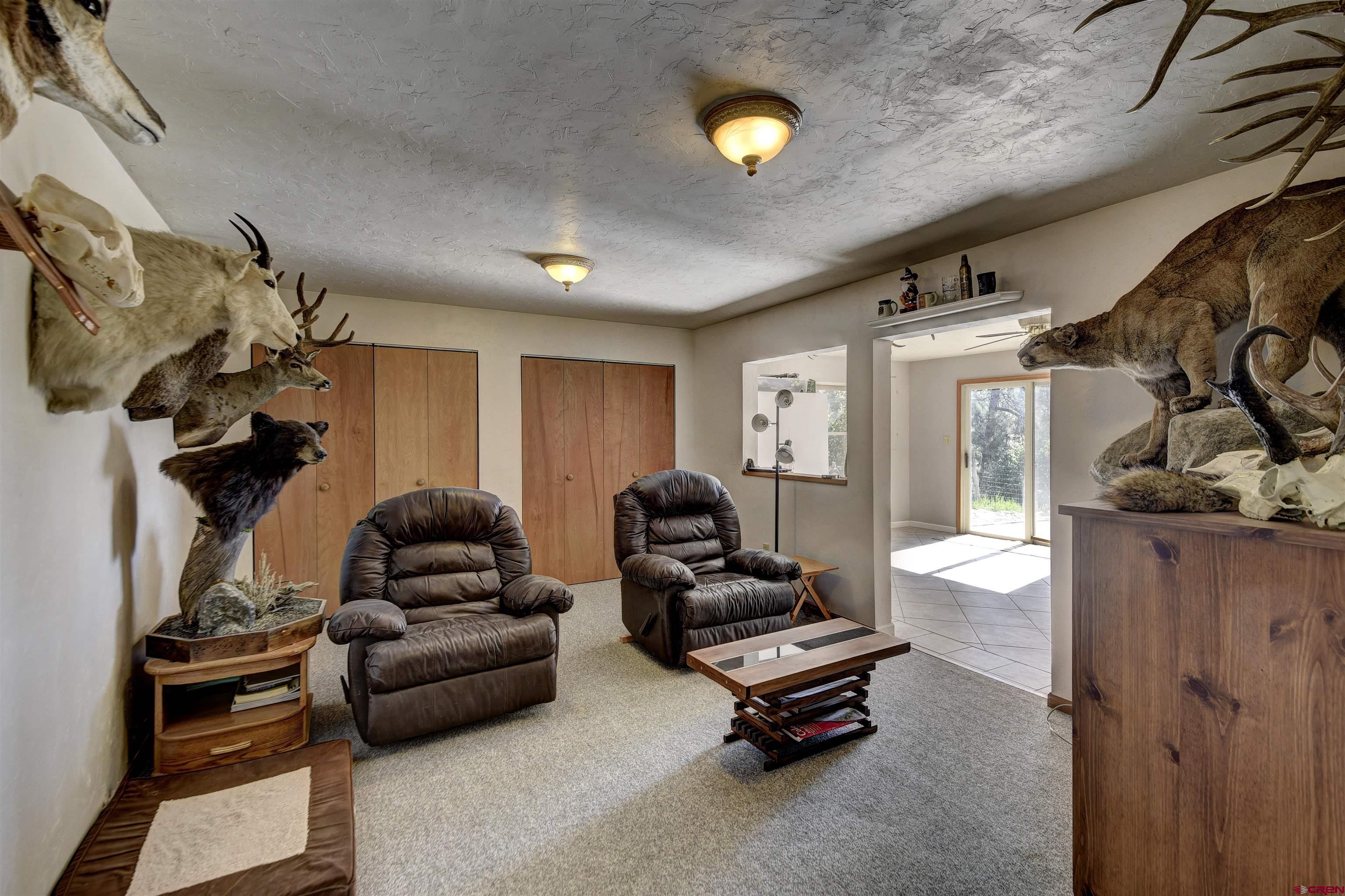 1172 Ridge Road Durango, CO 81303 - Photo 25 of 28 a living room with furniture gym equipment and a fireplace