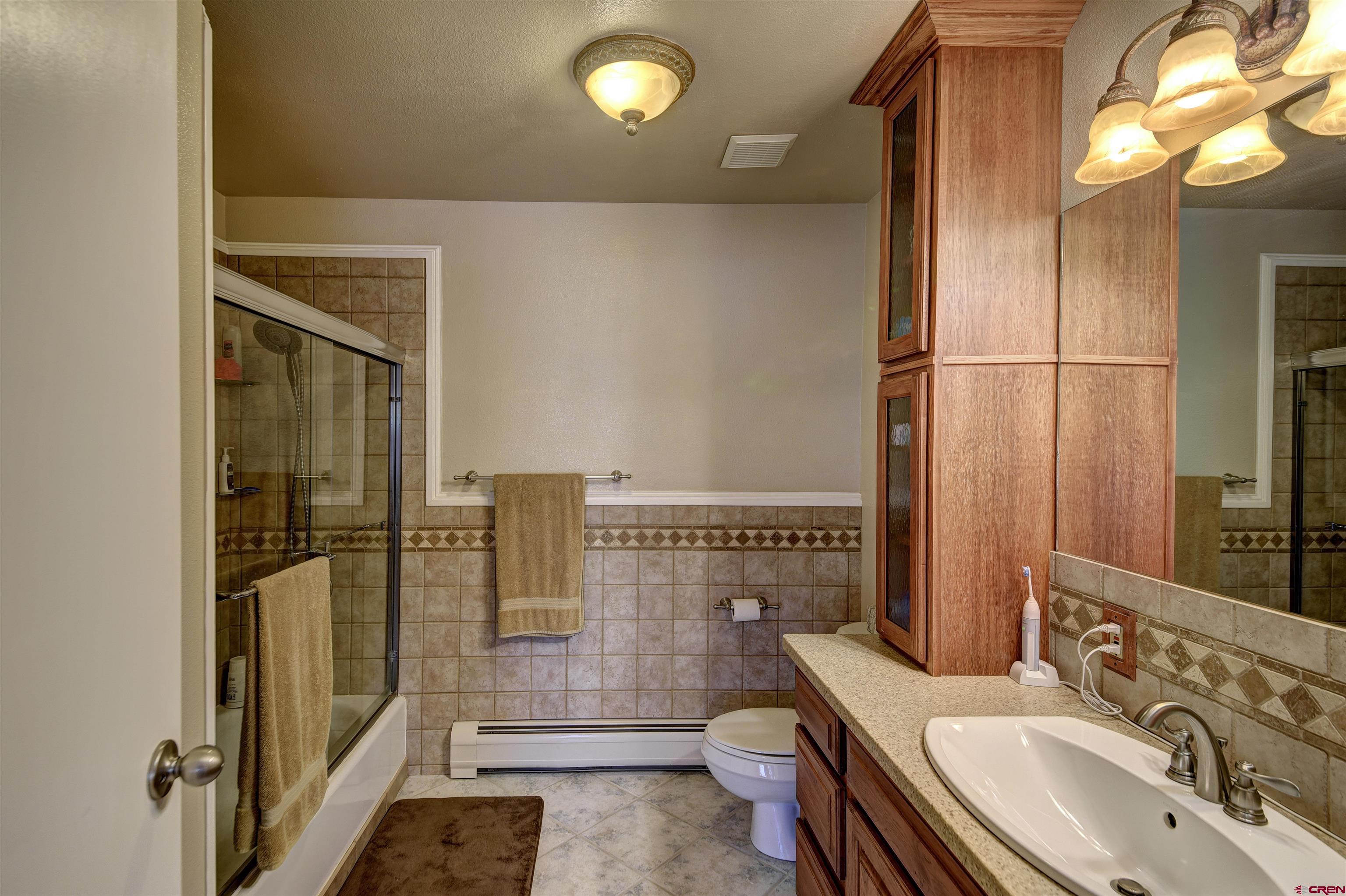 1172 Ridge Road Durango, CO 81303 - Photo 28 of 28 a bathroom with a sink a toilet a mirror and shower