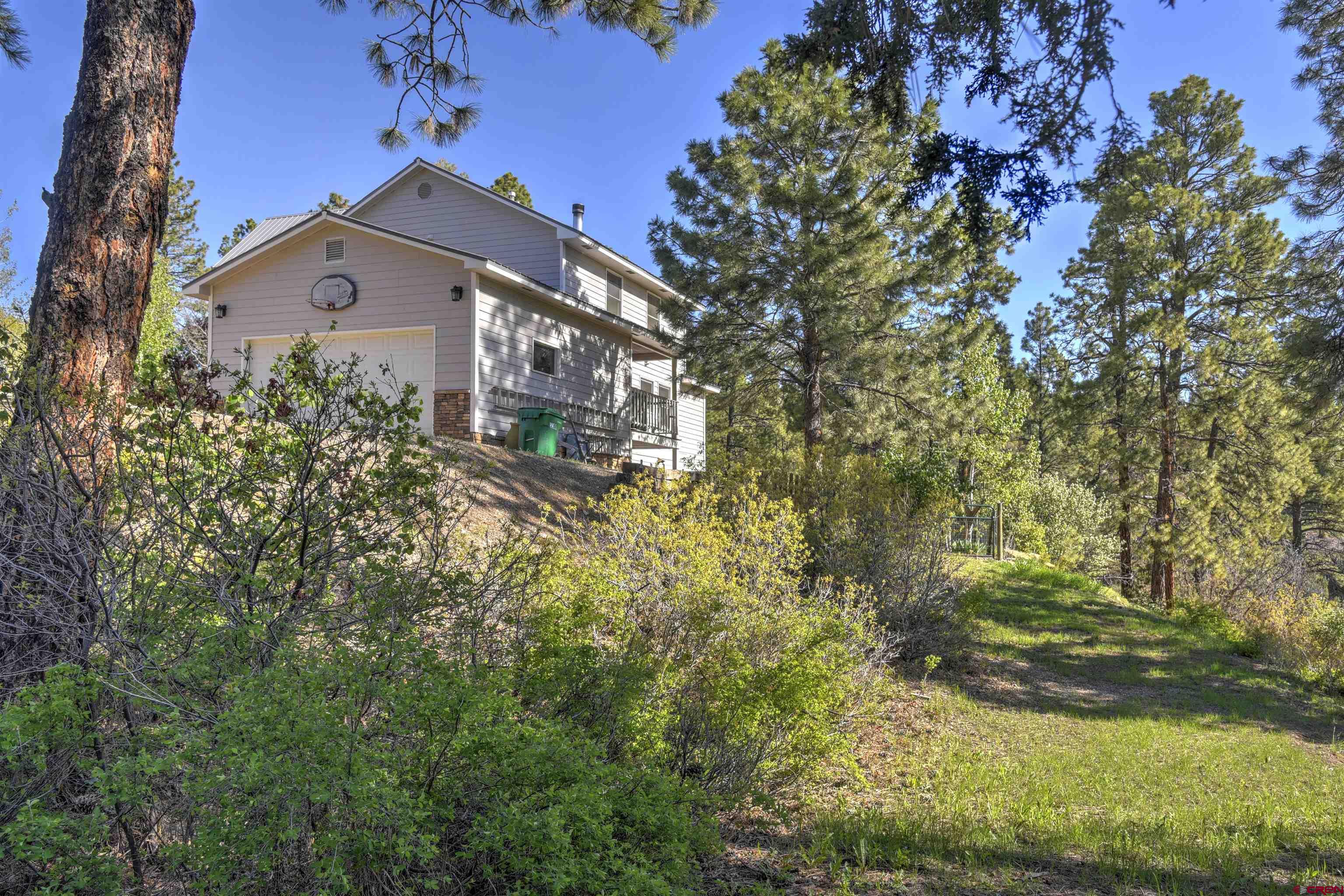 1172 Ridge Road Durango, CO 81303 - Photo 3 of 28 a front view of a house with a yard