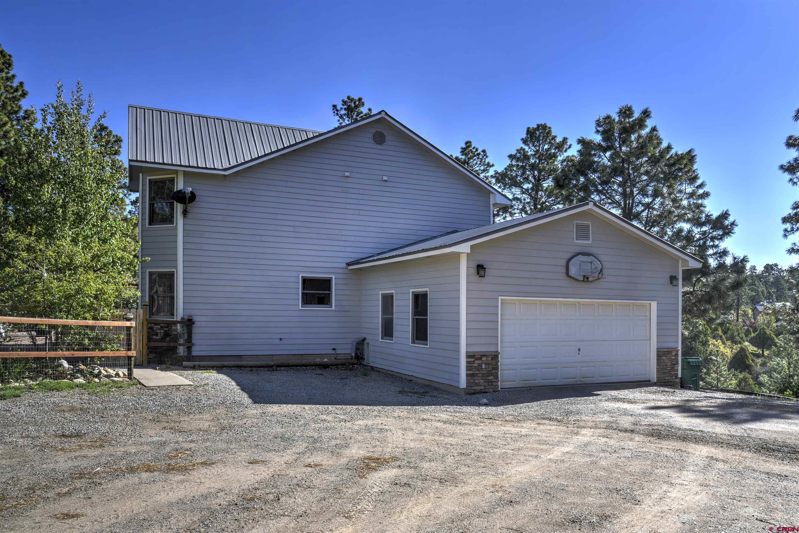 1172 Ridge Road Durango, CO 81303 - Photo 4 of 28 a front view of a house with a yard and garage