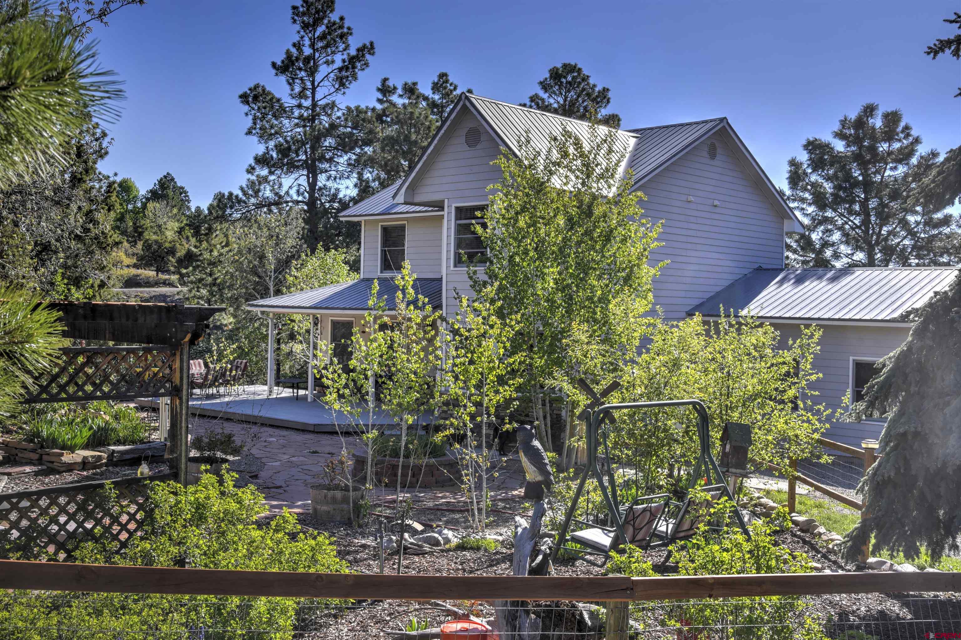 1172 Ridge Road Durango, CO 81303 - Photo 6 of 28 a front view of a house with a yard