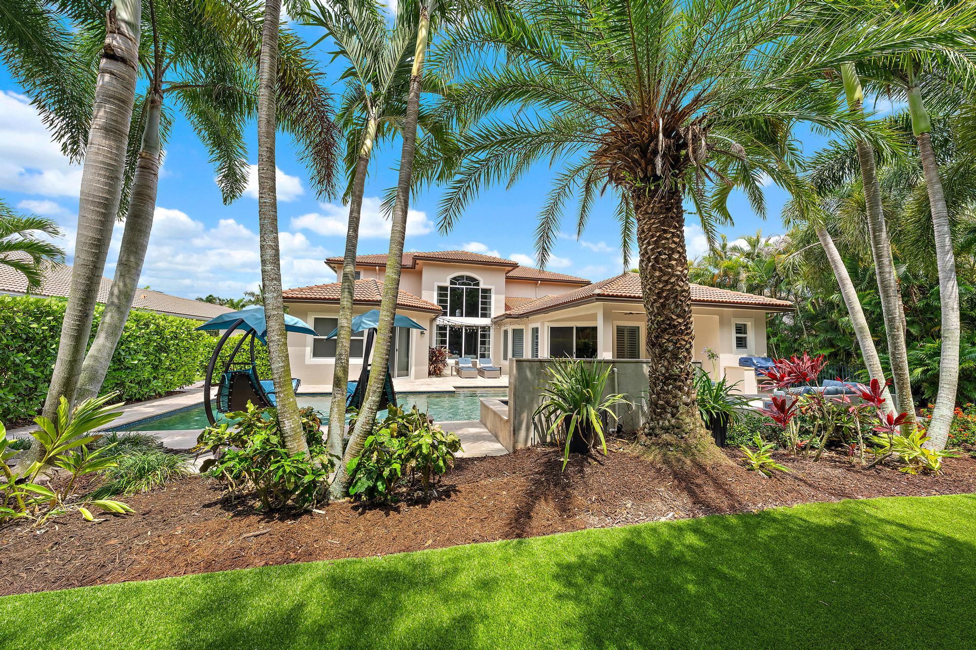 283 Rudder Cay Way Jupiter, FL 33458 - Photo 22 of 41 a front view of a house with a garden