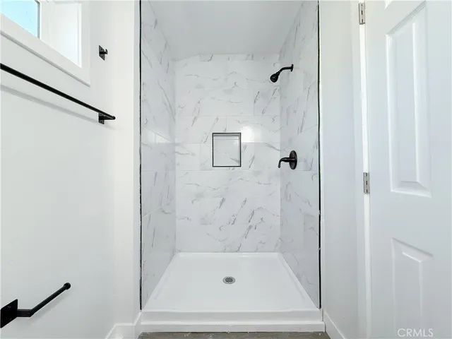a bathroom with a toilet a sink and shower